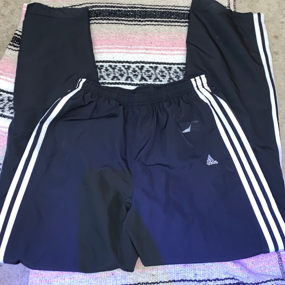 Black track pants with white stripes down legs